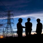 Silhouette,Man,Of,Engineers,Standing,At,Electricity,Station,Over,Blurred